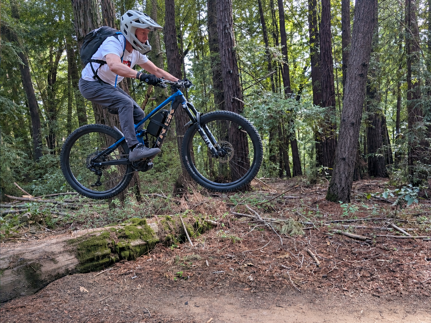Robert Portillo Mountain Biking - Jumping over a log on a mountain trail Robert Portillo Mountain Biking - Jumping over a log on a mountain trail