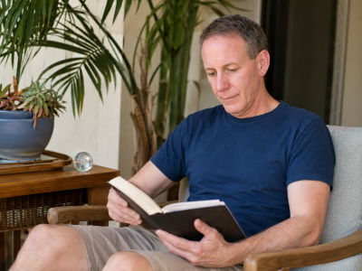 Robert Sitting and Reading a Book at his home
